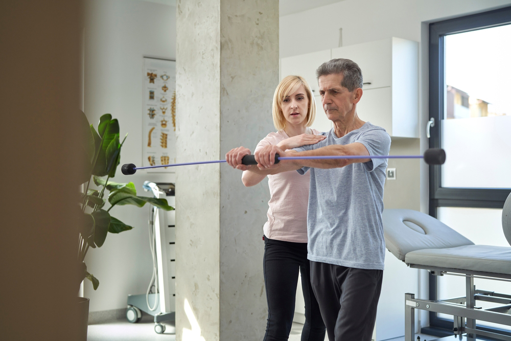 Female physical therapist working with man about his balance