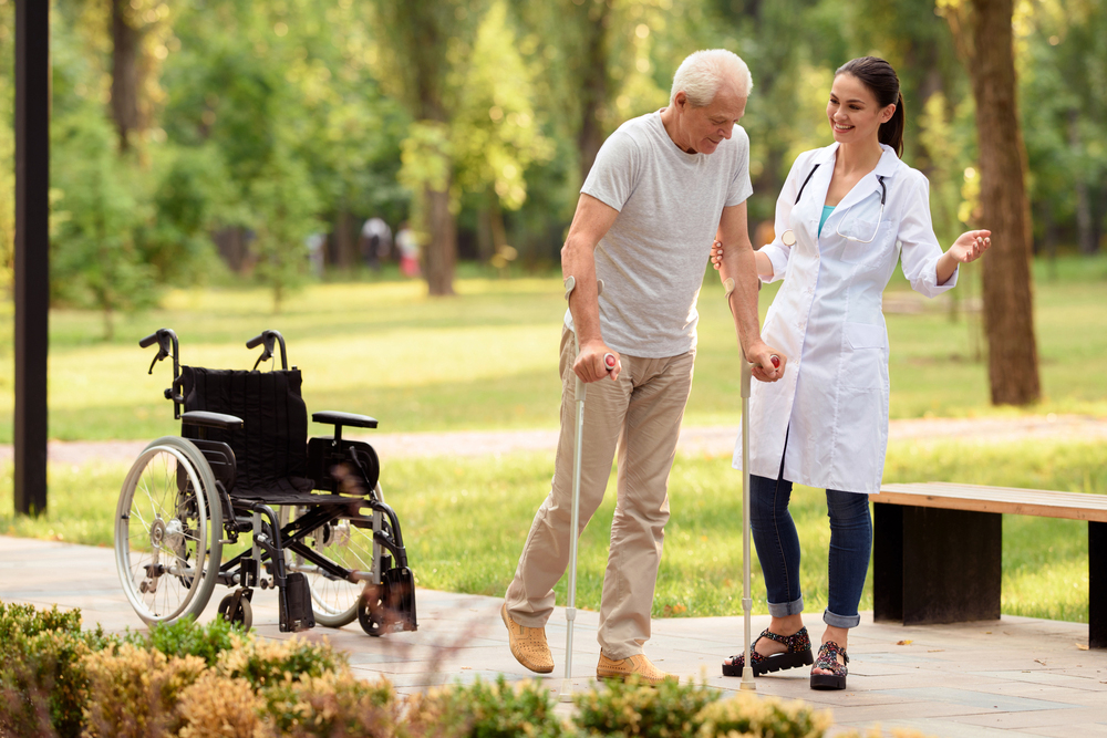 Doctor assisting patient with walking